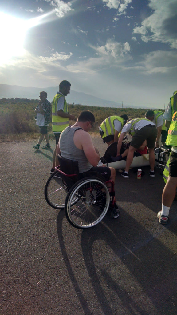 Handcyclist sits next to handcycle