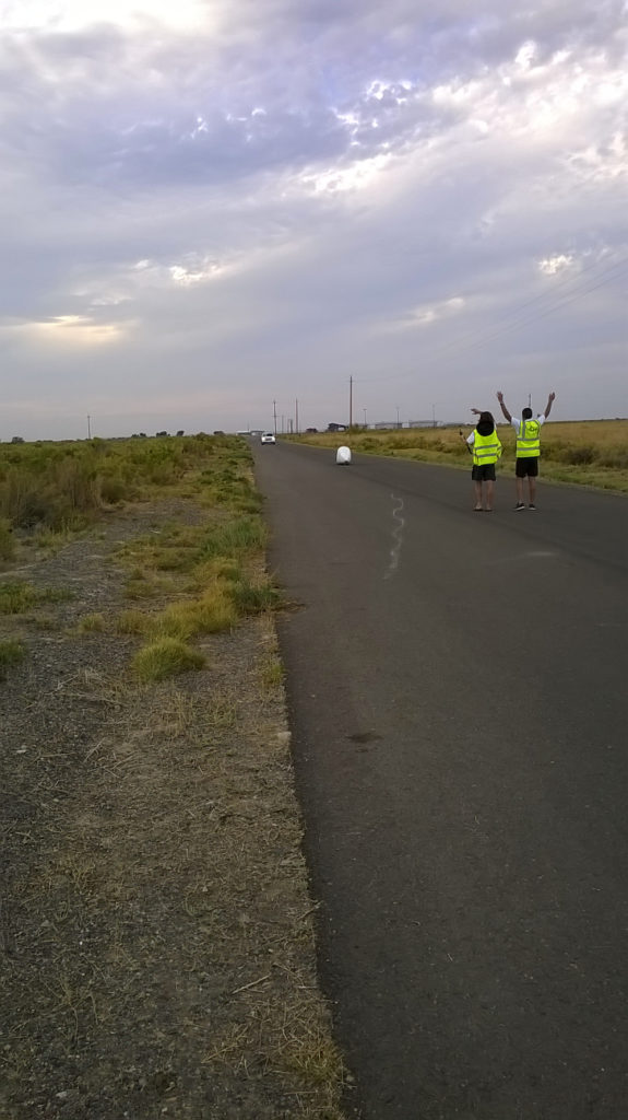 Handcycle riding on road towards catch team