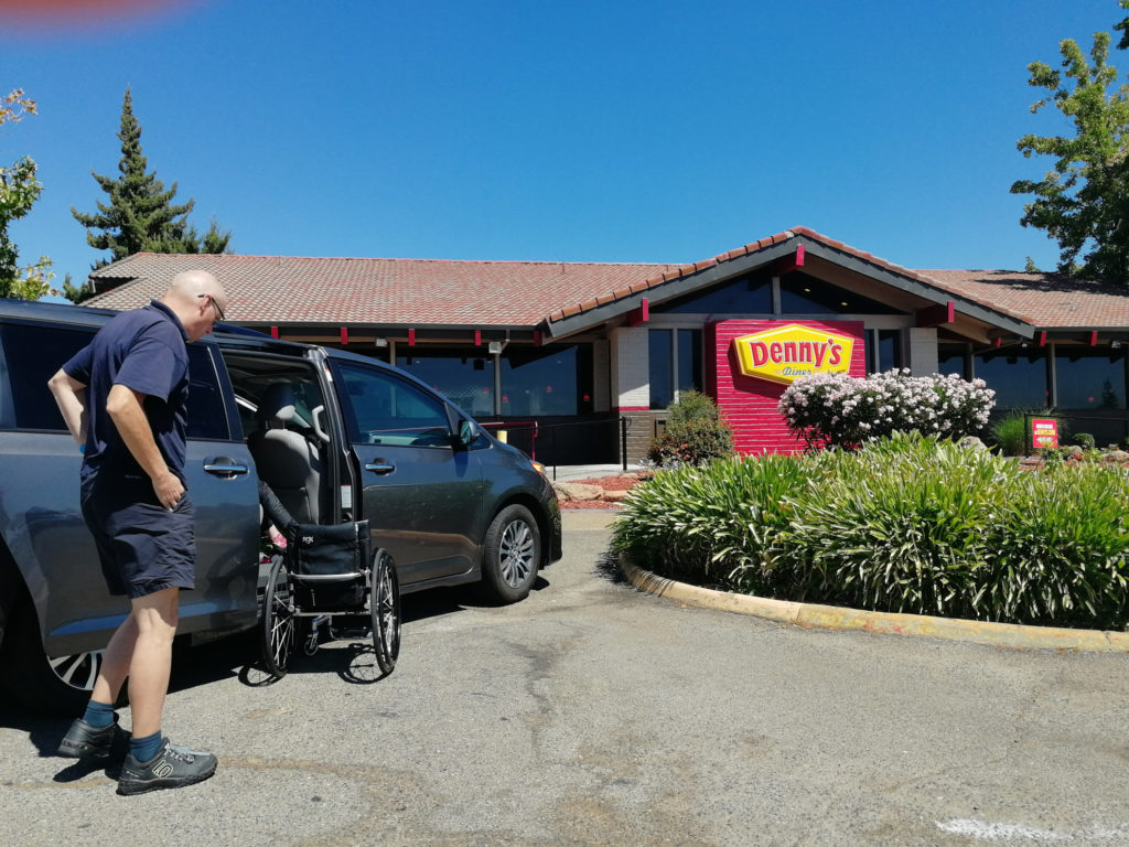 John helping with wheelchairs outside of Denny's restaurant