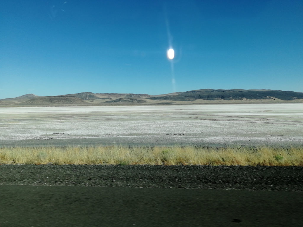 View of some barren land from a roadway